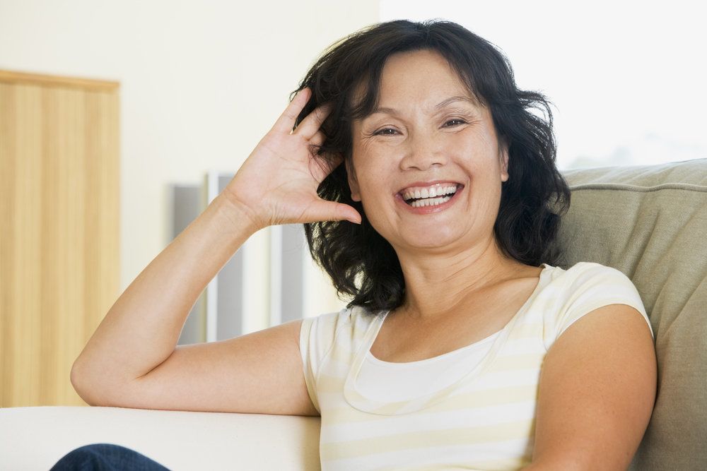A woman in a recliner smiles